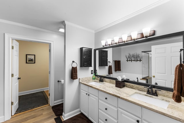 165 Indian Valley Ln, Swansea, SC 29160 - bathroom featuring double vanity, crown molding, baseboards, and wood finished floors