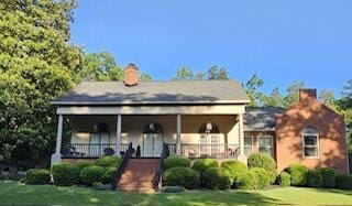 165 Indian Valley Ln, Swansea, SC 29160 - bungalow-style home with covered porch, a front yard, and a chimney