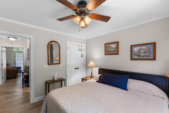 165 Indian Valley Ln, Swansea, SC 29160 - bedroom featuring wood finished floors, crown molding, baseboards, a ceiling fan, and a closet