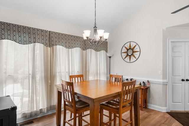 165 Indian Valley Ln, Swansea, SC 29160 - dining space with light wood-style flooring, a chandelier, and vaulted ceiling