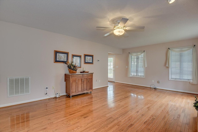 interior space featuring ceiling fan, light hardwood / wood-style flooring, and a textured ceiling