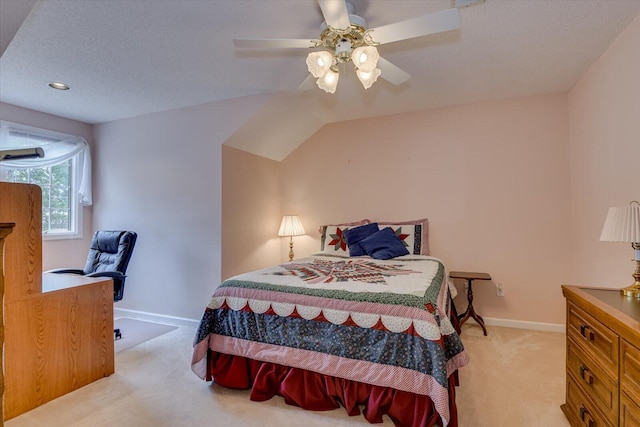 bedroom featuring ceiling fan, light carpet, and a textured ceiling