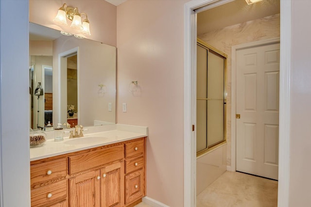 bathroom with vanity and combined bath / shower with glass door