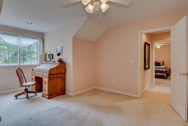 carpeted office with ceiling fan, lofted ceiling, and a textured ceiling