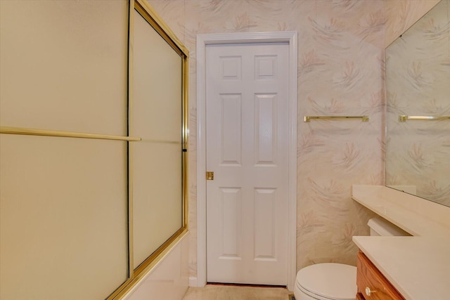 full bathroom with vanity, toilet, and enclosed tub / shower combo