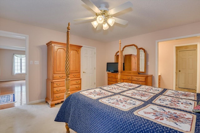 bedroom with ceiling fan and light colored carpet