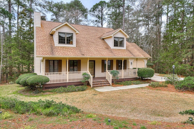 cape cod-style house featuring a front lawn and covered porch