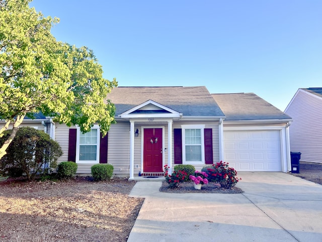 single story home featuring a garage and driveway