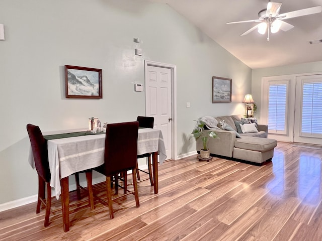 dining space featuring light hardwood / wood-style floors, ceiling fan, and lofted ceiling