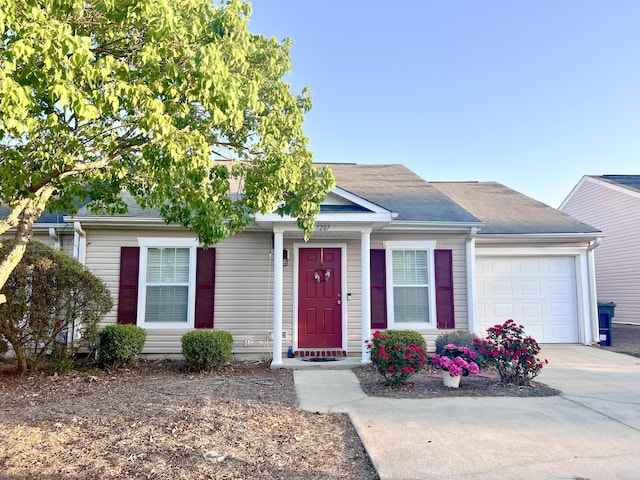 view of front facade with an attached garage, roof with shingles, and concrete driveway