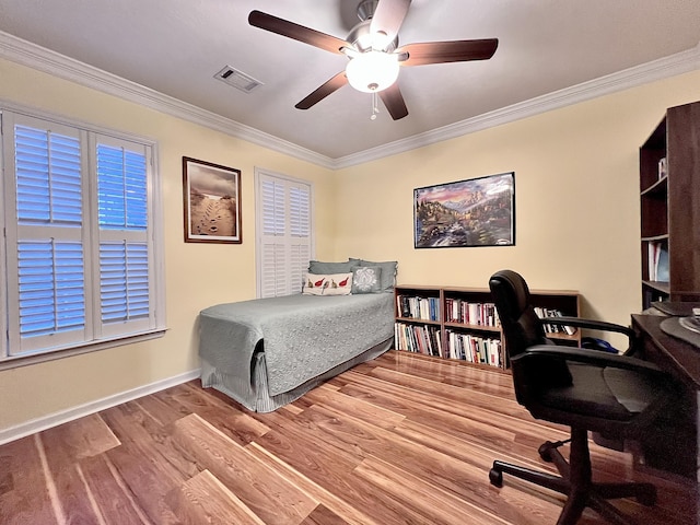 bedroom with ceiling fan, light hardwood / wood-style floors, and ornamental molding