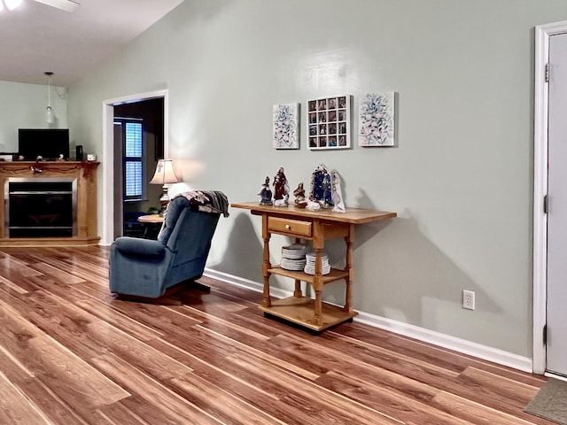 sitting room with hardwood / wood-style flooring and lofted ceiling