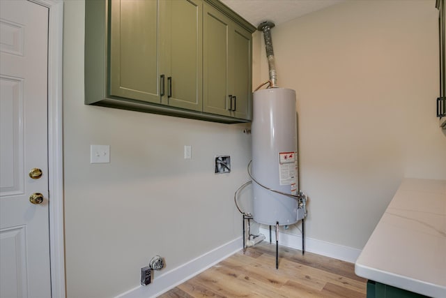 3022 Shady Ln, Hephzibah, GA 30815 - laundry room with water heater, light wood-style flooring, cabinet space, baseboards, and hookup for an electric dryer