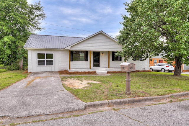 3022 Shady Ln, Hephzibah, GA 30815 - view of front facade featuring covered porch, a front lawn, brick siding, metal roof, and driveway