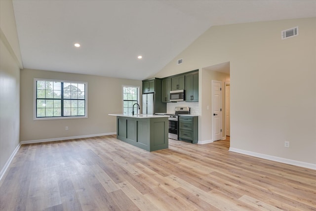 3022 Shady Ln, Hephzibah, GA 30815 - kitchen with green cabinetry, appliances with stainless steel finishes, a sink, light countertops, and light wood-type flooring