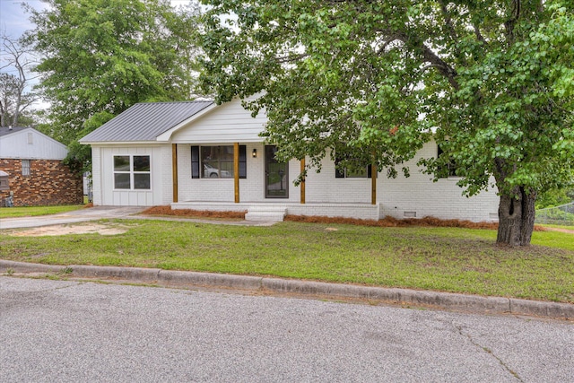 3022 Shady Ln, Hephzibah, GA 30815 - view of front facade with brick siding, a front lawn, metal roof, and covered porch