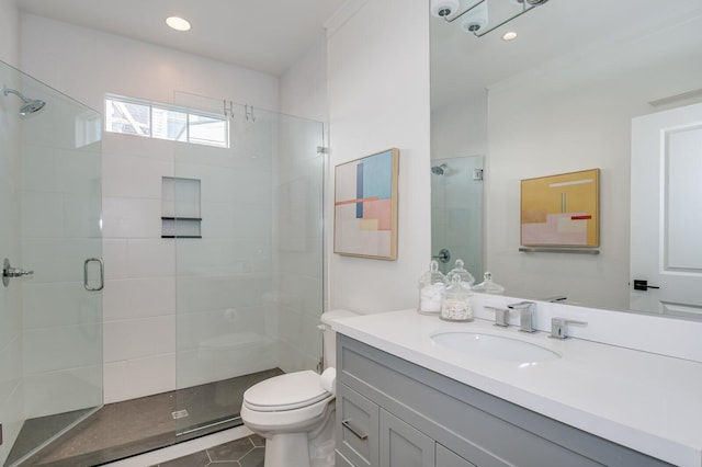 bathroom featuring tile patterned flooring, vanity, toilet, and an enclosed shower