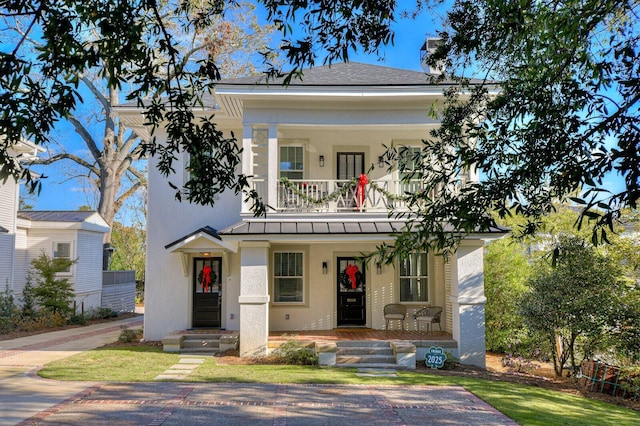 view of front of house with a porch and a balcony