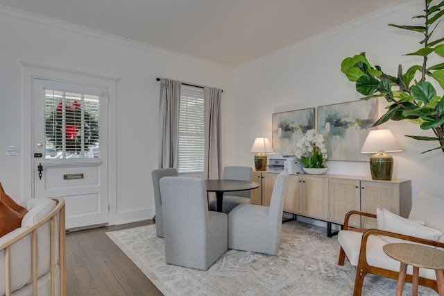 dining space with light hardwood / wood-style floors and ornamental molding