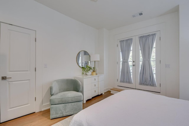 bedroom featuring french doors and light hardwood / wood-style floors