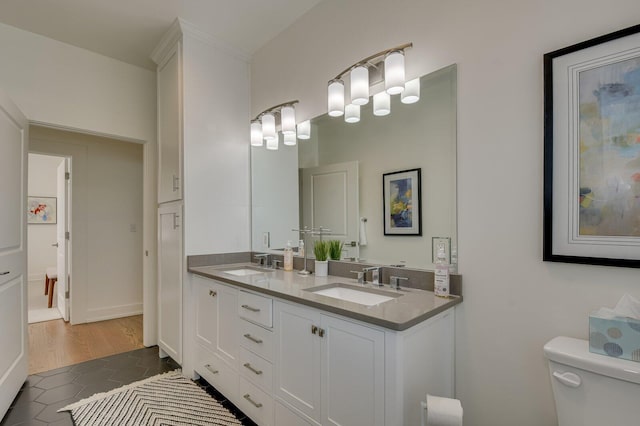 bathroom with tile patterned floors, vanity, and toilet