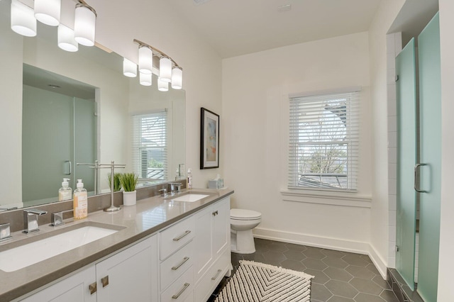 bathroom with tile patterned flooring, vanity, toilet, and a shower with door