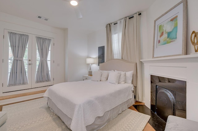 bedroom featuring access to exterior, ceiling fan, french doors, and light hardwood / wood-style floors