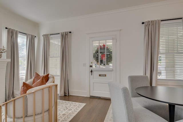 dining room with light wood-type flooring and ornamental molding