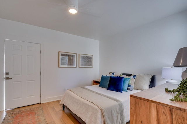 bedroom with ceiling fan and light wood-type flooring