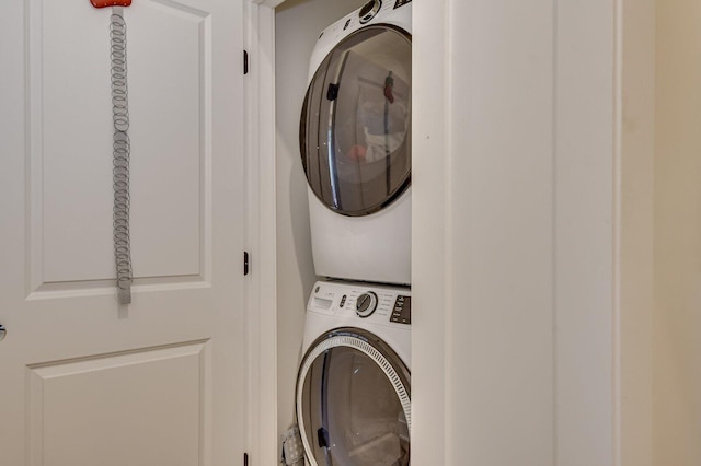 washroom featuring stacked washer and dryer