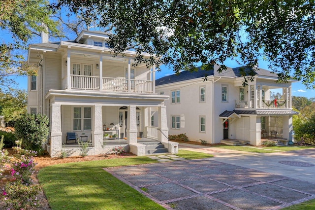 view of front of house featuring covered porch and a balcony