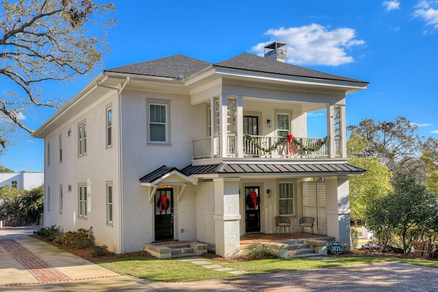 view of front of home with covered porch and a balcony