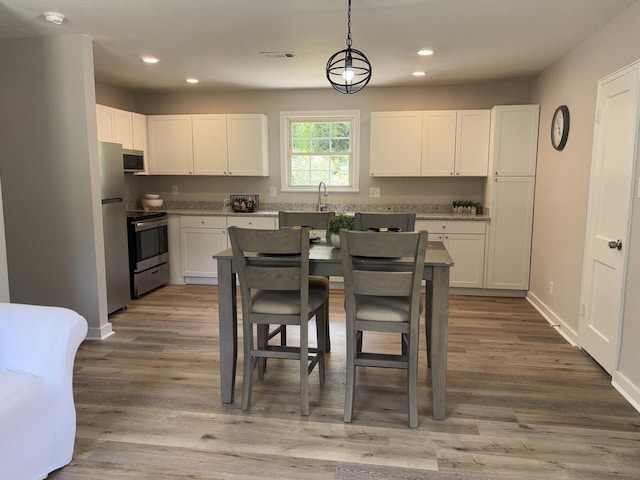 2438 Ridge Rd, Augusta, GA 30906 - kitchen featuring stainless steel appliances, recessed lighting, white cabinetry, and visible vents