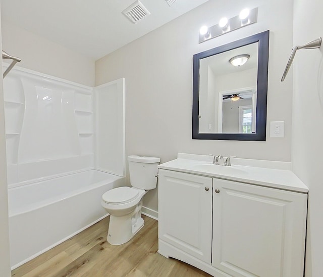 full bathroom featuring vanity, shower / tub combination, ceiling fan, toilet, and wood-type flooring