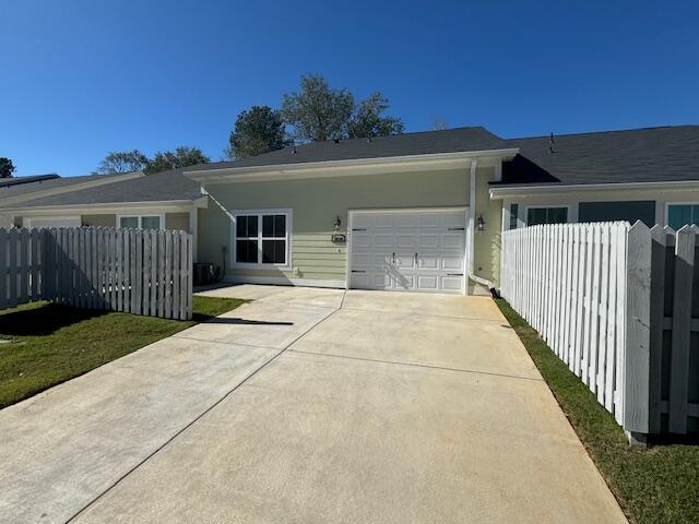 view of side of property featuring a yard and a garage