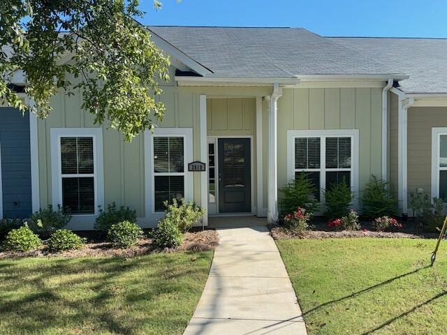 doorway to property with a yard