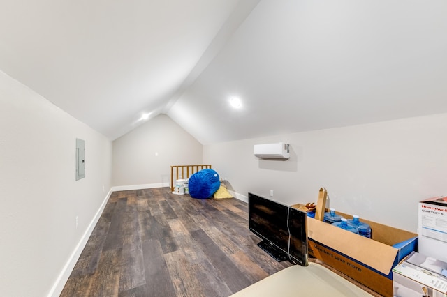 additional living space featuring a wall unit AC, baseboards, electric panel, vaulted ceiling, and wood finished floors
