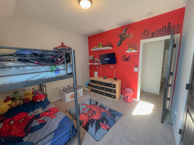 bedroom with carpet and a textured ceiling