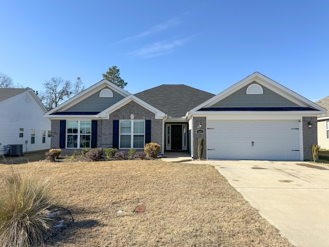 single story home featuring a garage and central air condition unit