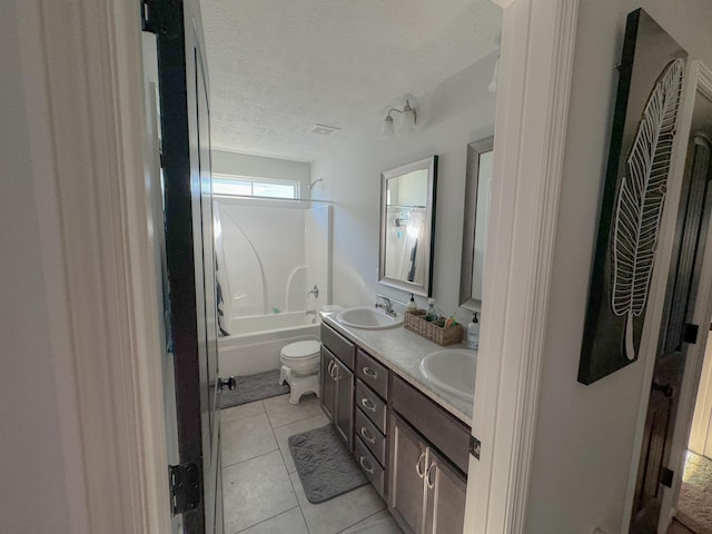 full bathroom with vanity, shower / tub combination, tile patterned floors, toilet, and a textured ceiling