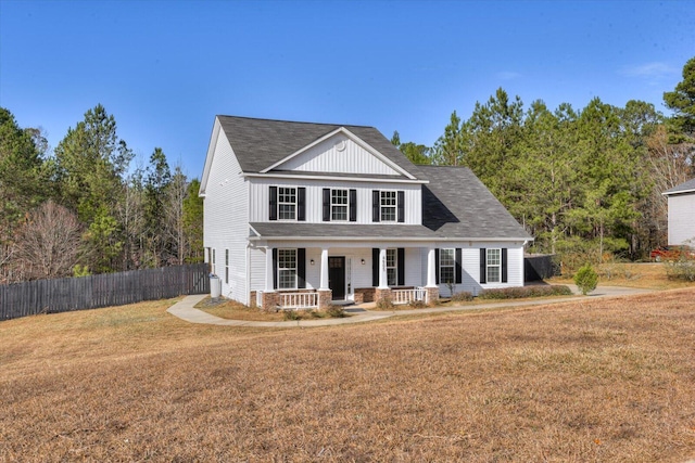 view of front of property with covered porch and a front lawn