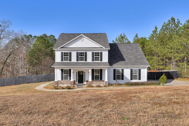 view of front of property featuring covered porch and a front yard