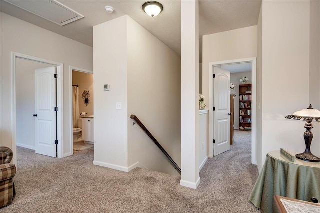 hallway featuring light carpet