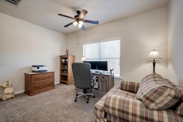 carpeted office space with ceiling fan