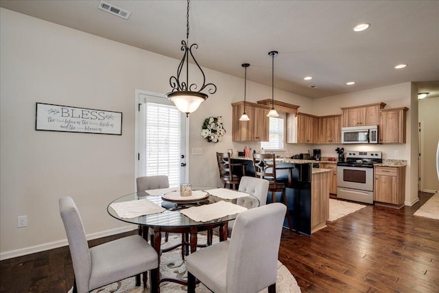 dining space featuring dark wood-type flooring