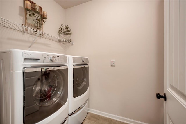 clothes washing area with washing machine and clothes dryer