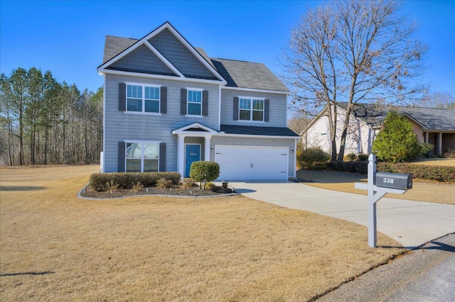 view of front of property with a front yard and a garage