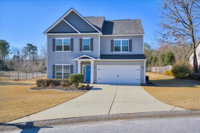 view of front of house featuring a front yard and a garage