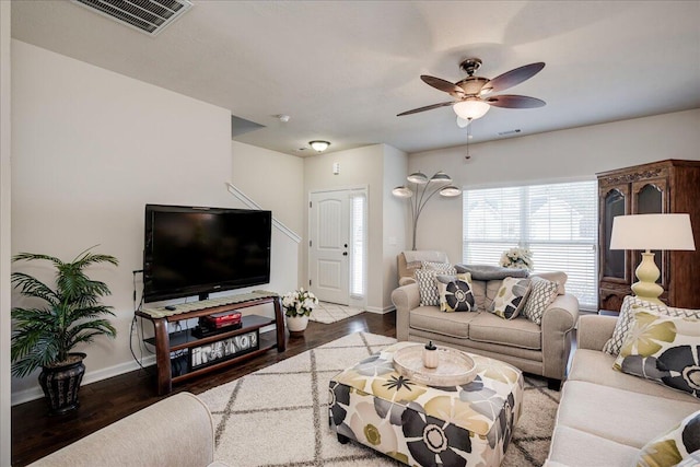 living room featuring ceiling fan and dark hardwood / wood-style floors