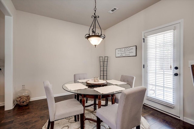 dining room featuring plenty of natural light and dark wood-type flooring